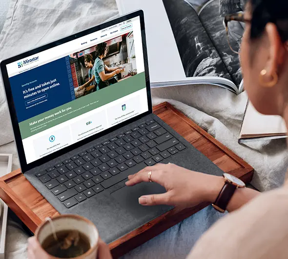 Surface Laptop used by a lady on a wooden slab